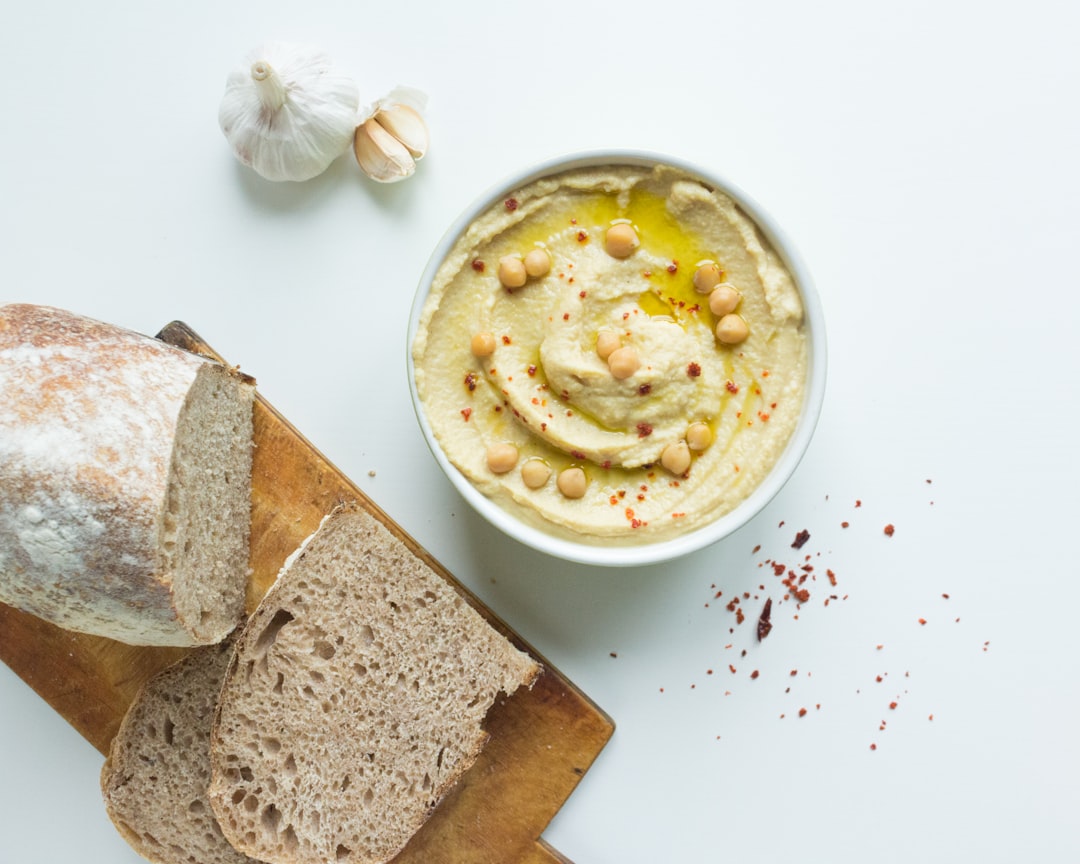 Close-up of hummus, tahini, and toum revealing hidden carbs in Middle Eastern sauces for low-carb meal planning